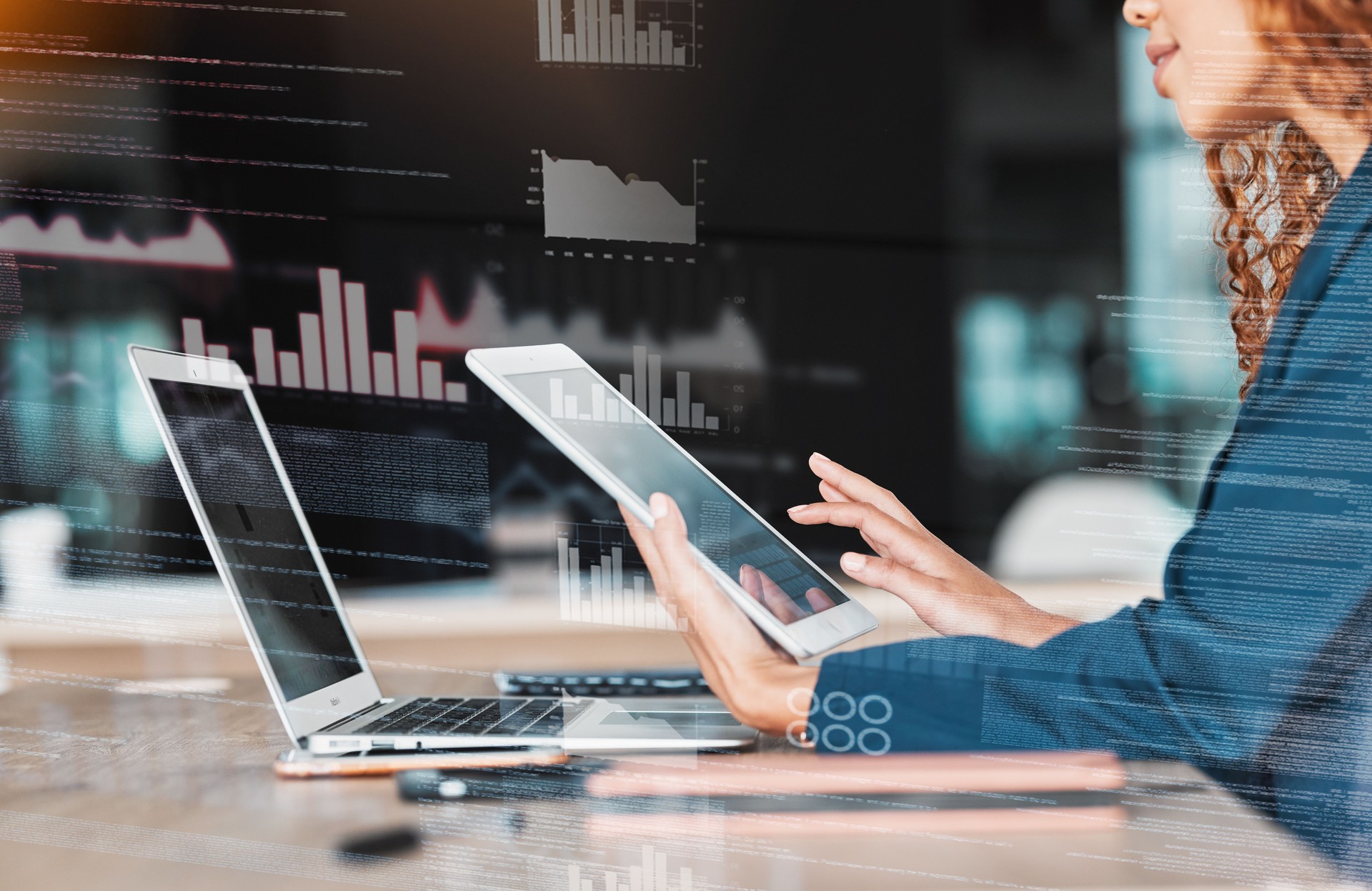 Businesswoman, laptop and tablet in analytics, data planning or marketing strategy at office desk. Hands of female analyst in management on touchscreen or computer for corporate statistics on overlay